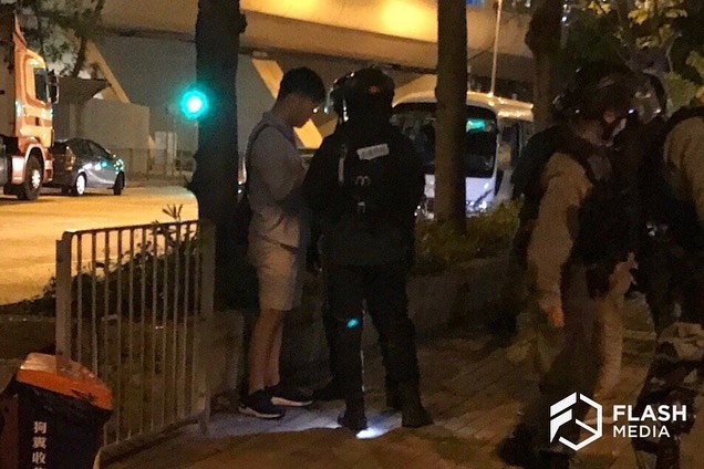 Riot police (PTU) request resident cards before letting residents pass