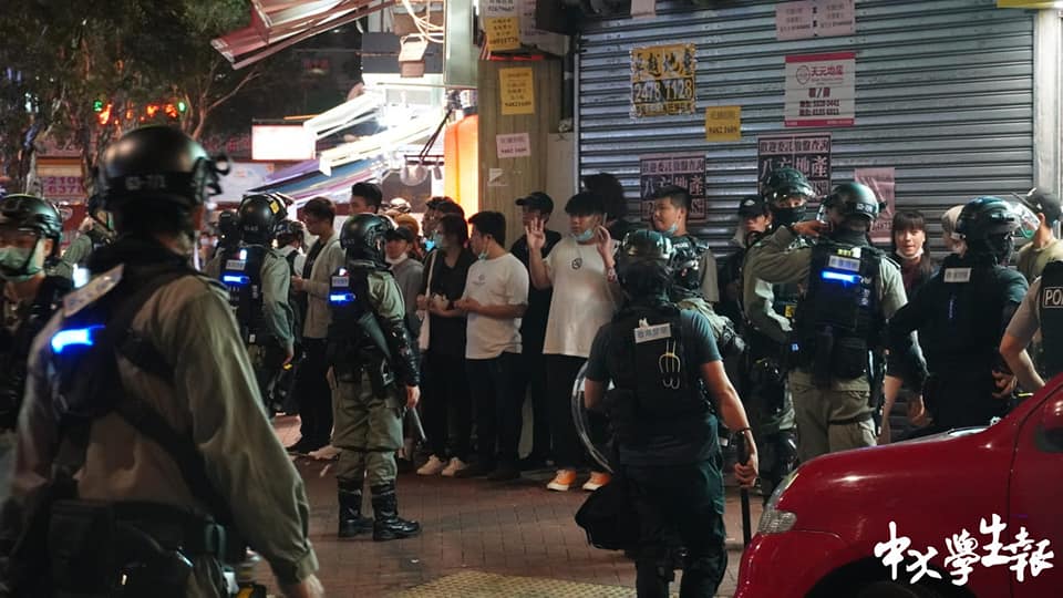 Riot police accuse people waiting outside restaurant of illegal assembly