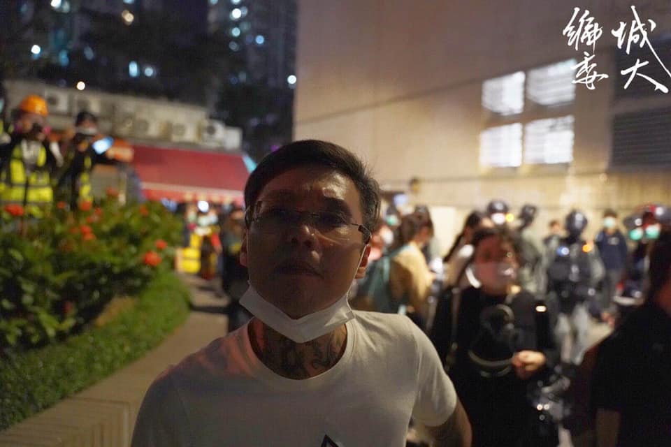After tattooed man provoked citizens and insulted the press, riot police tapped his shoulder and escorted him to leave