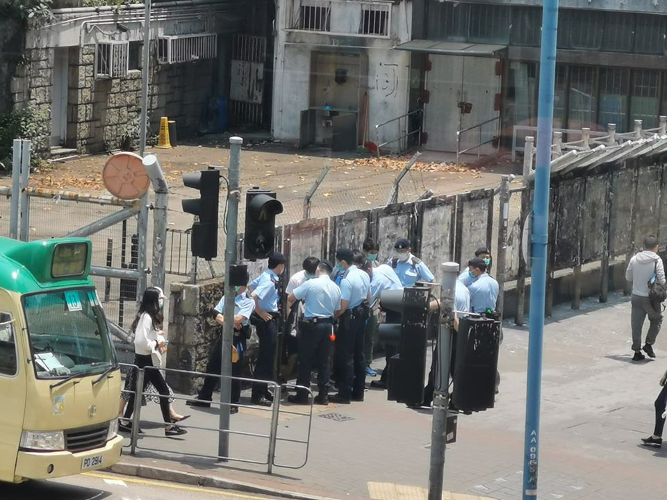 Uniformed police officers verbally abuse and stop citizens who are reading postings on the street, threaten to “drag you into San Uk Ling”