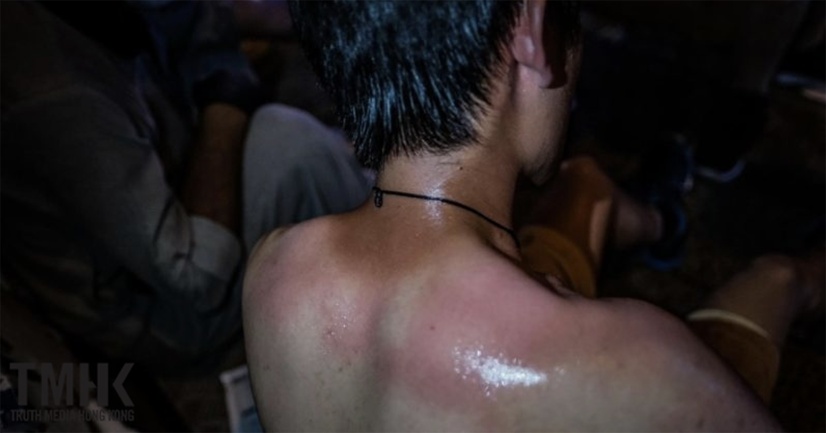 Large number of reporters surrounded by riot police, who ordered them to kneel, and swept them with pepper spray. Photograph was forbidden.